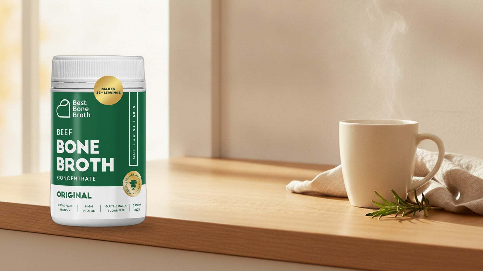 Best Bone Broth Original Beef concentrate bottle beside a warm mug on a bright morning kitchen counter.